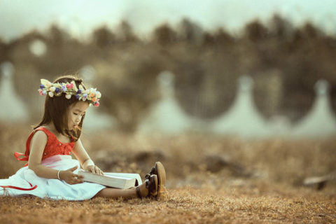 Little girl reading a book