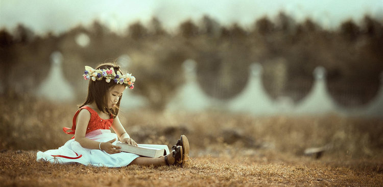 Little girl reading a book